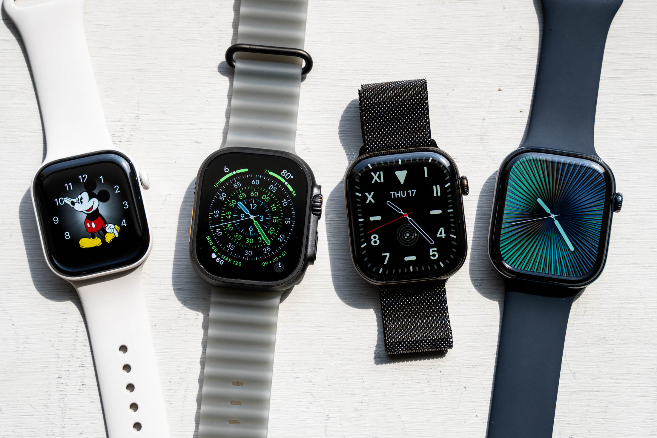 4 Apple Watches next to each other.