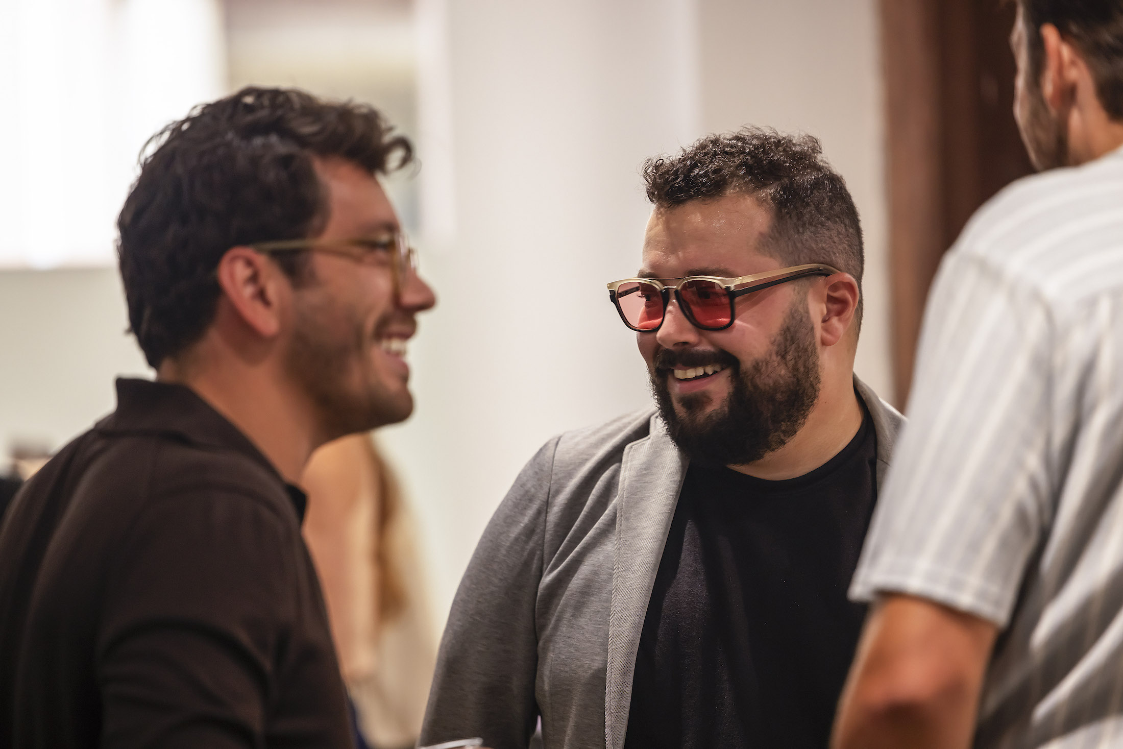 Three men talking and laughing