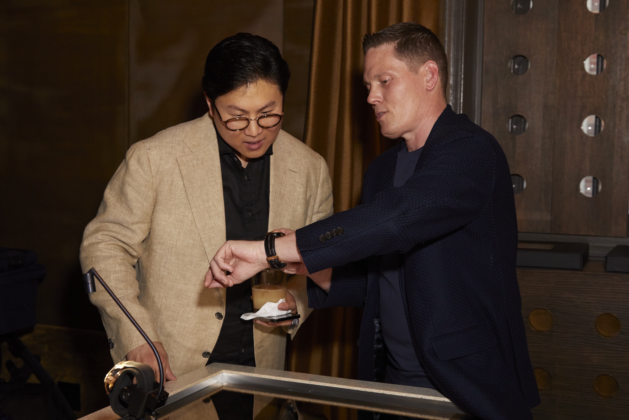 Two men looking at watches
