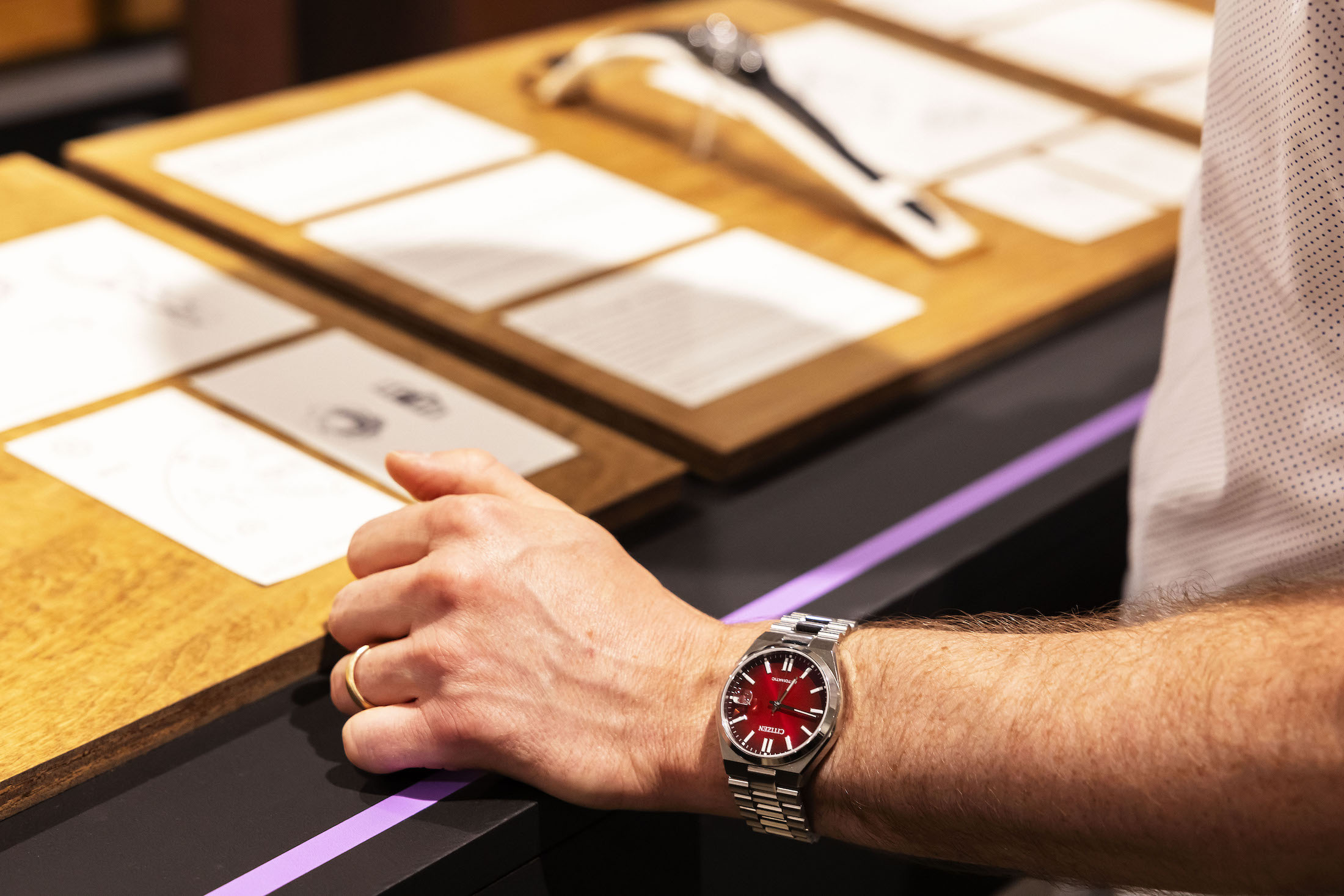 A red watch on a man's wrist