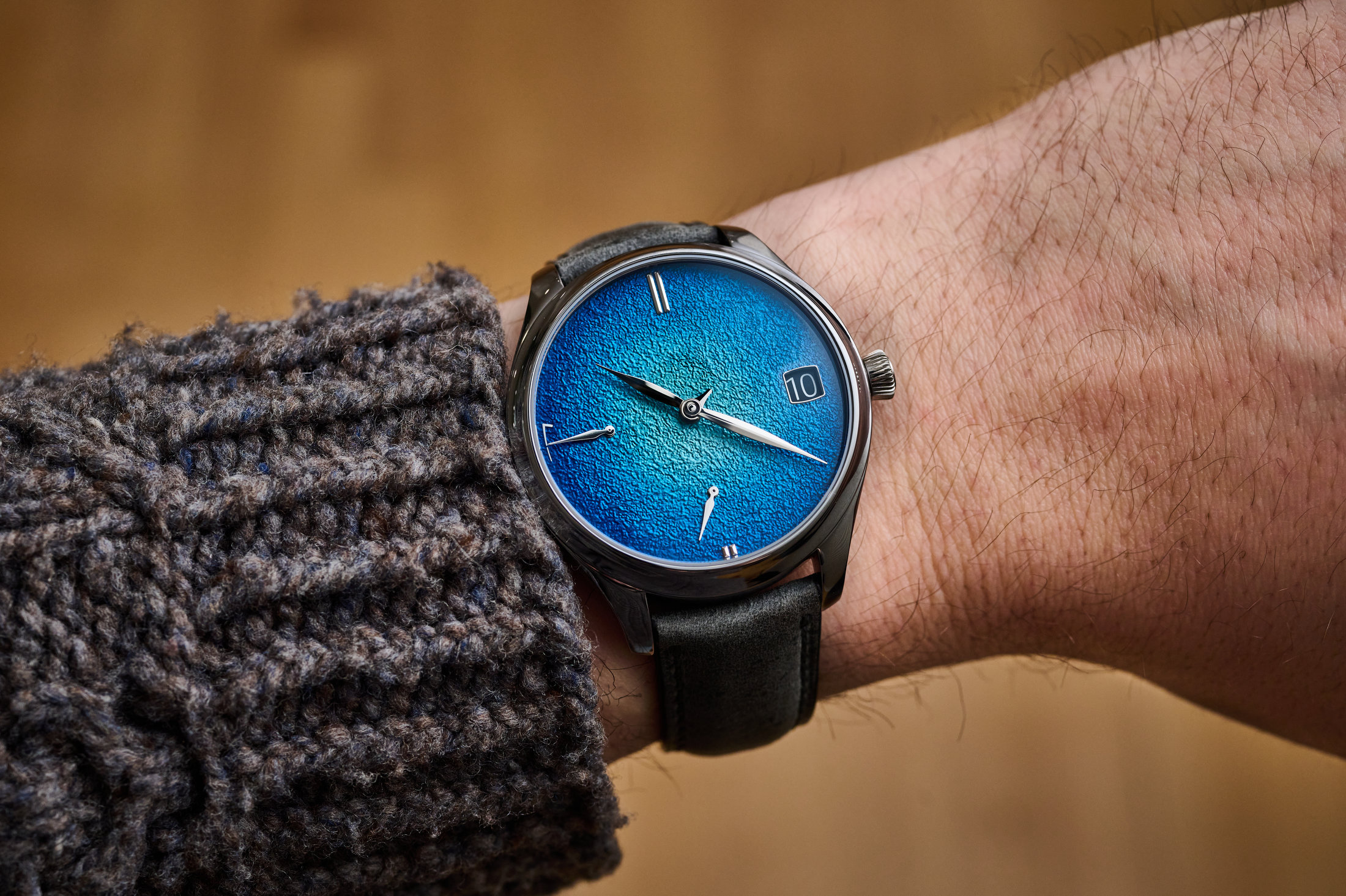 A wrist shot of the Moser Endeavor Perpetual Calendar with fumé grand feu enamel dial