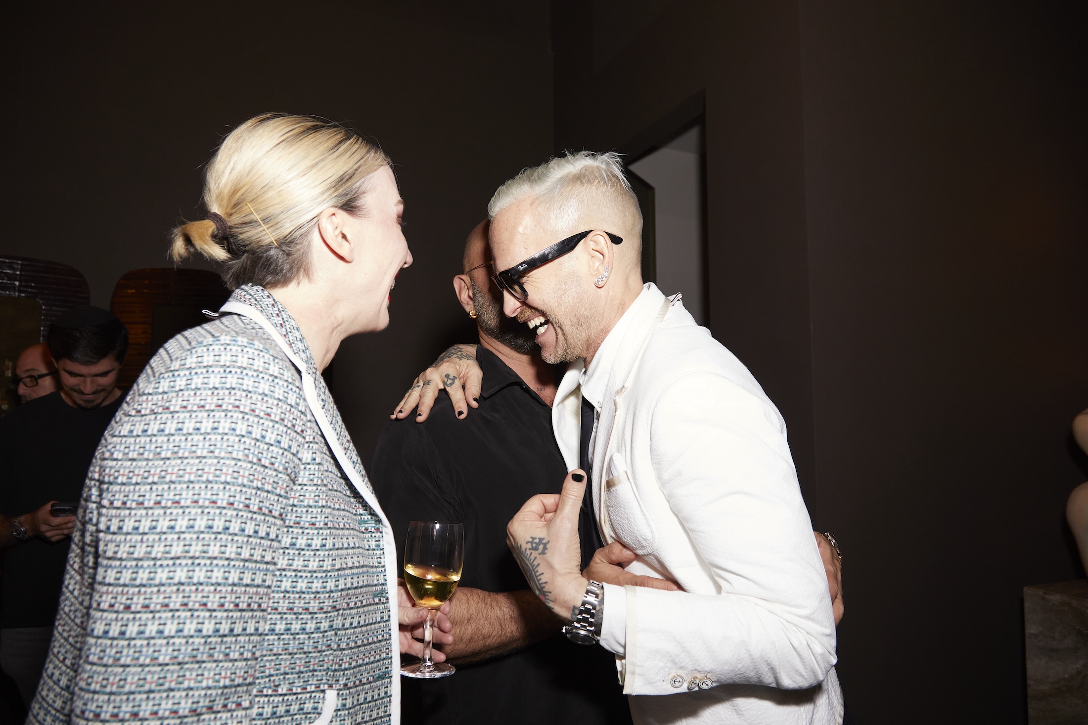 Three people laughing and embracing
