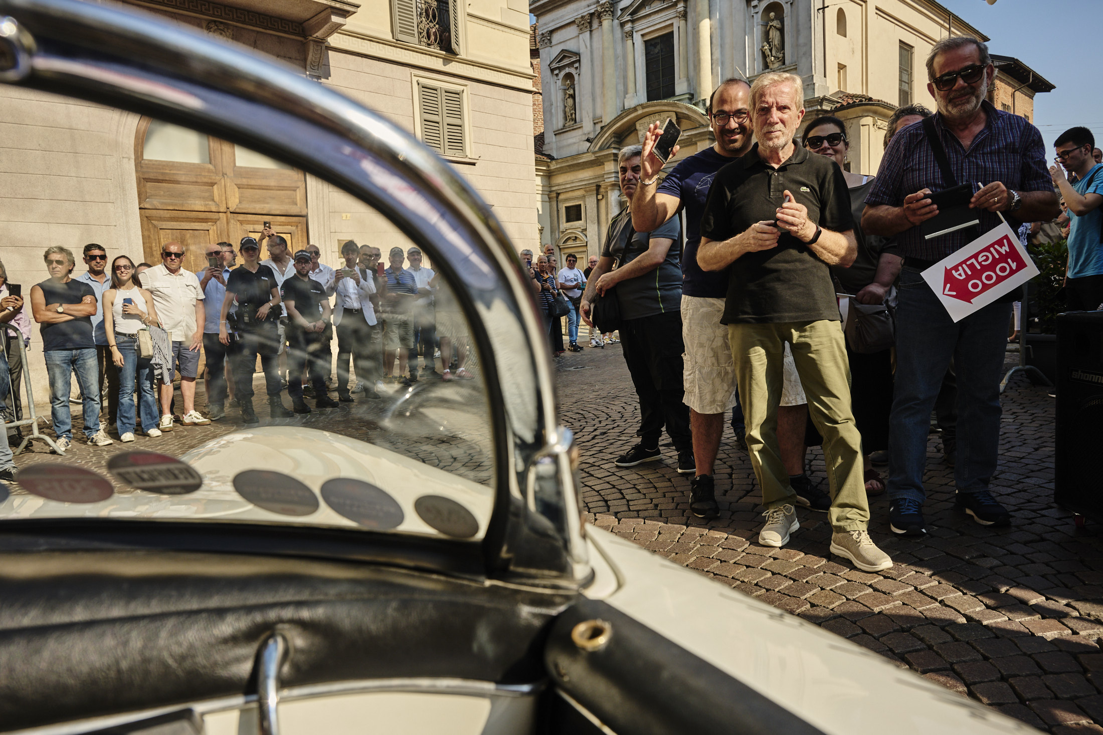 People watching from behind a barrier