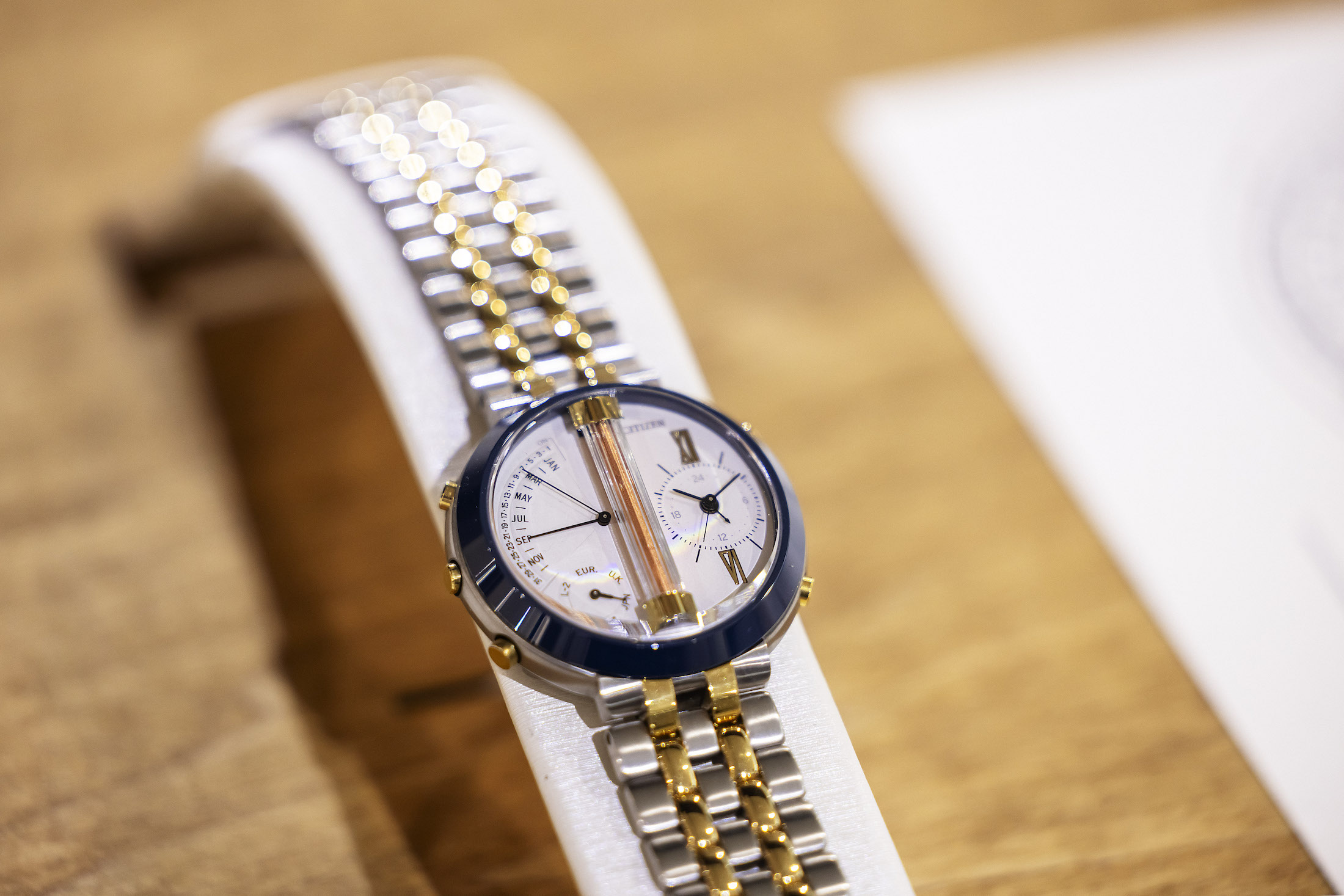 A CITIZEN watch with a copper antenna in the middle, and gold bracelet