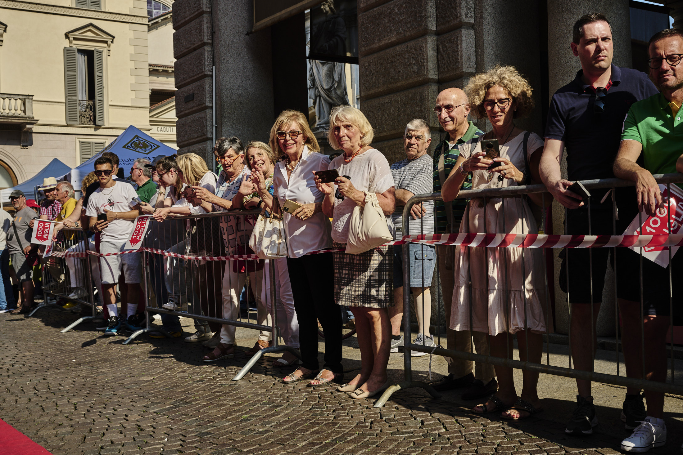People watching from behind a barrier