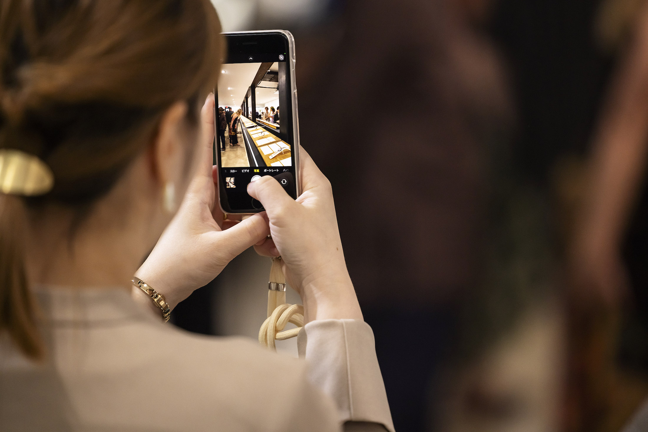 A woman taking a picture with her cellphone