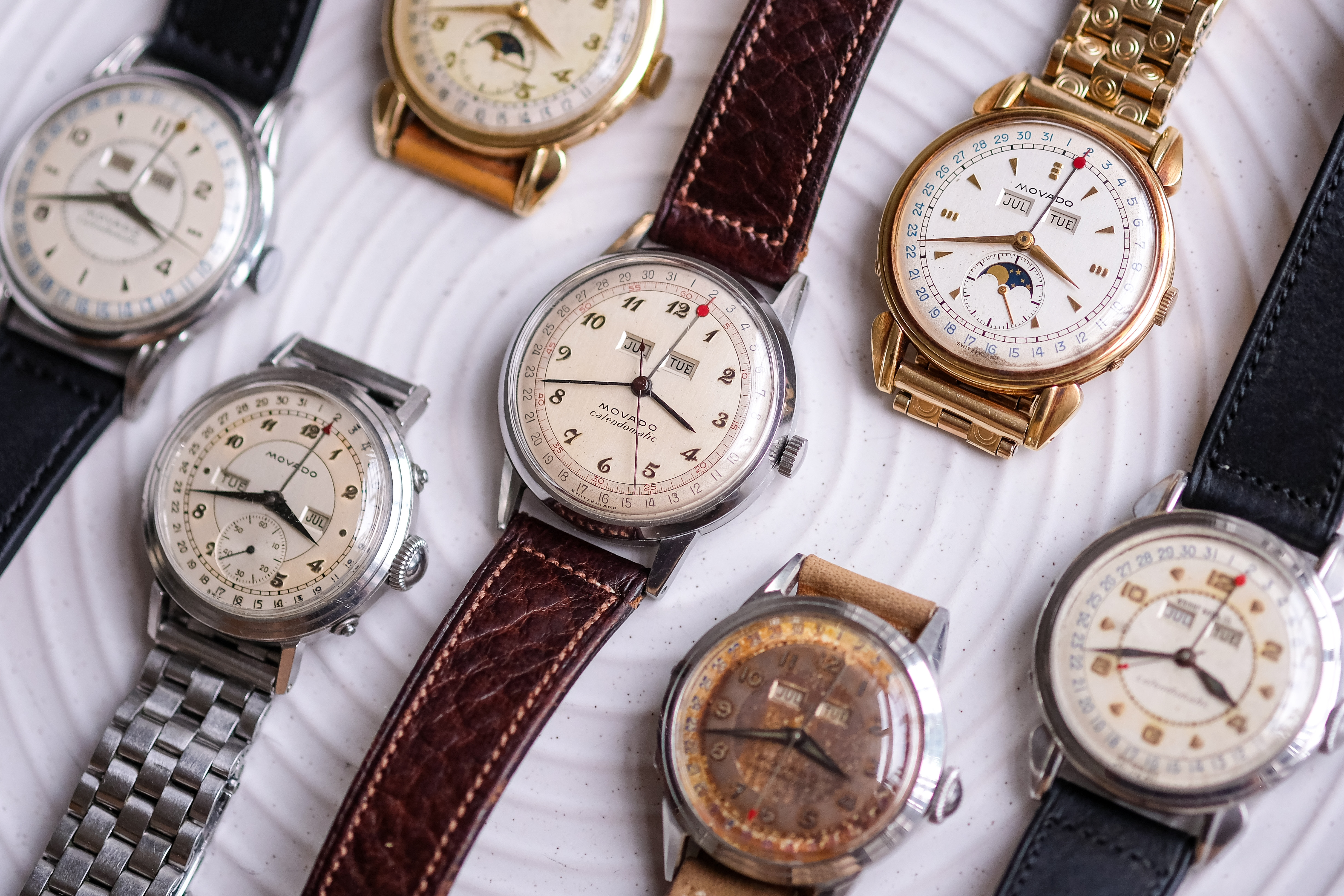 a group of Movado calendar watches