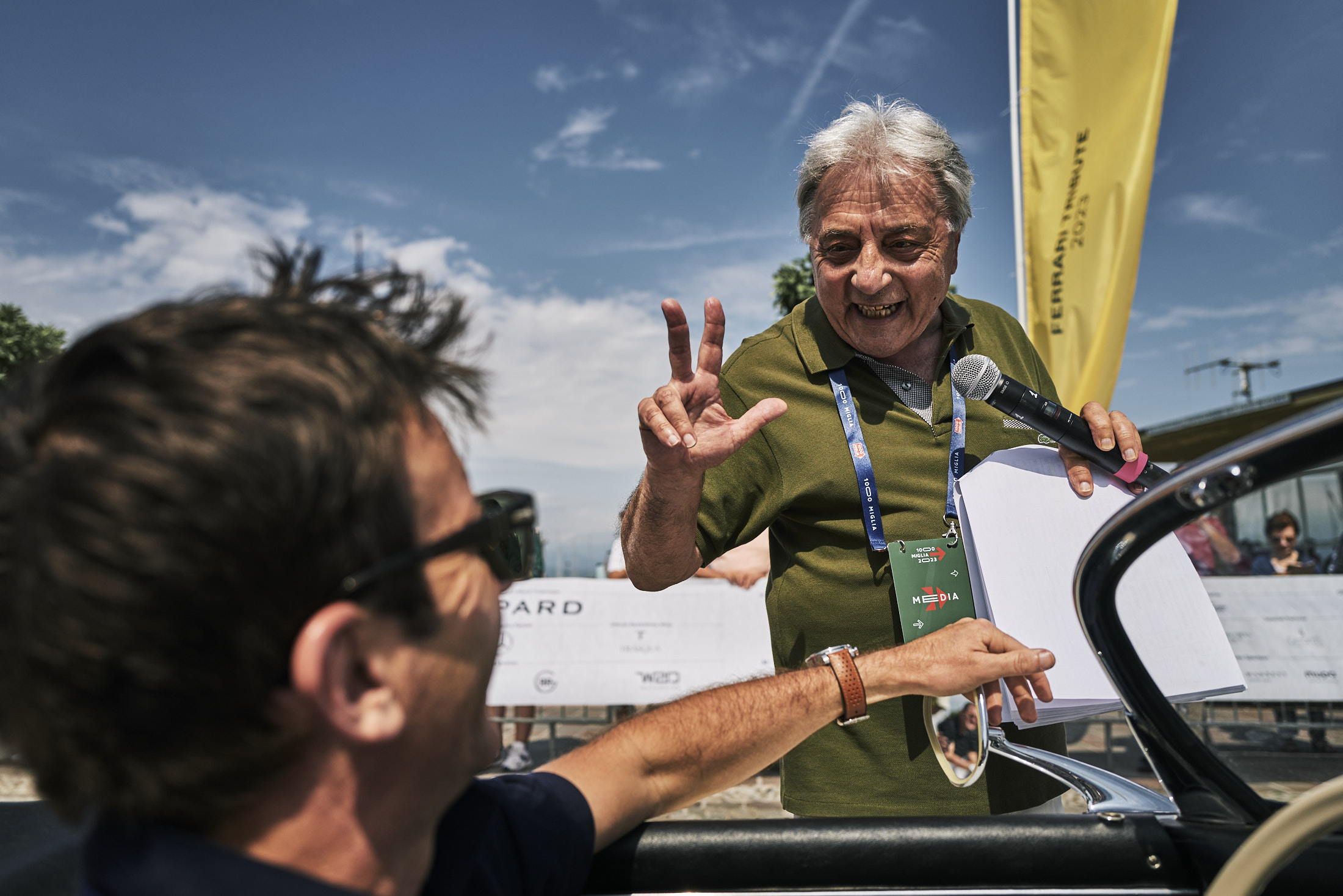 A commentator talking to Romain Dumas at the Mille Miglia