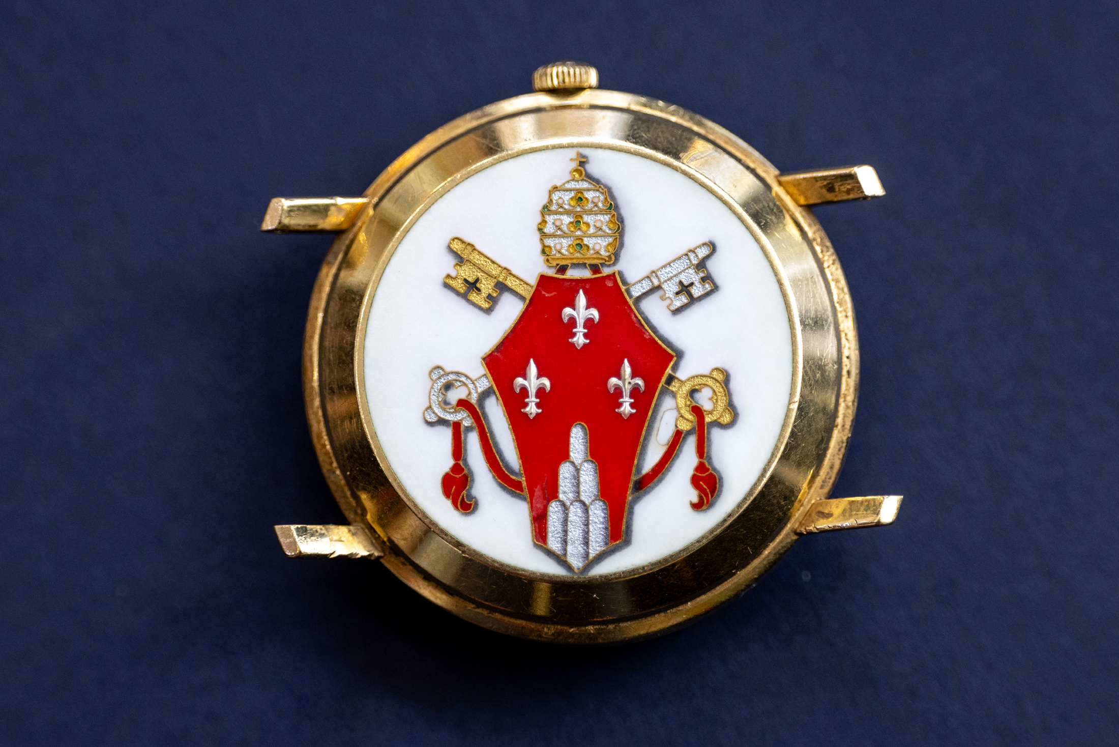 A watch caseback with an ornate clerical design