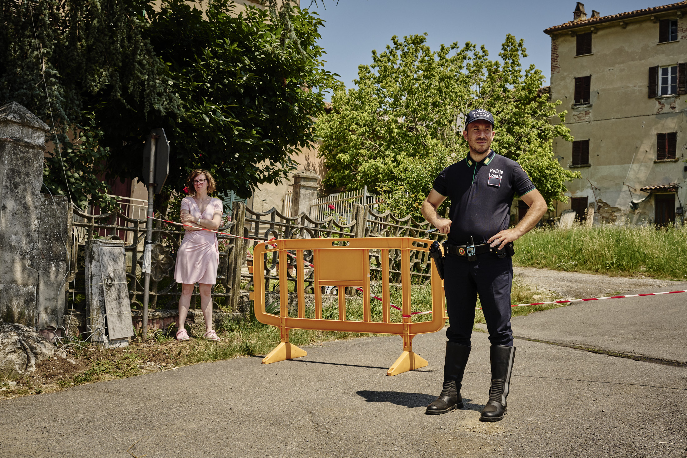 People waiting by the side of the road
